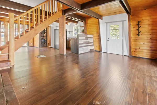 a view of an entryway with wooden floor
