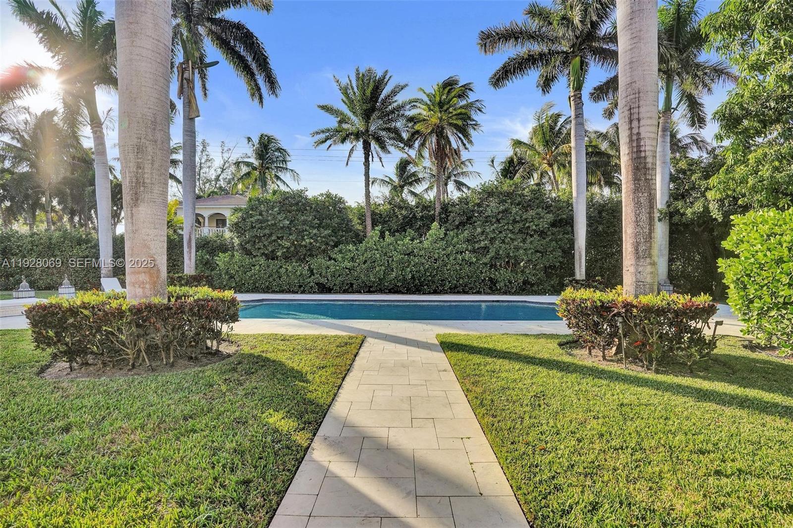 1281 Banyan Road Boca Raton, FL 33432 - Photo 23 of 69 a view of swimming pool with a table and chairs