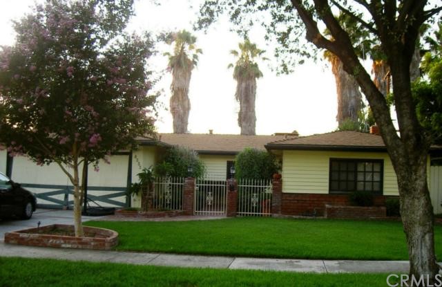 8253 Acapulco Place Riverside, CA 92504 - Photo 1 of 1 FRONT YARD VIEW. NOTE QUAINT BRICK COURTYARD.