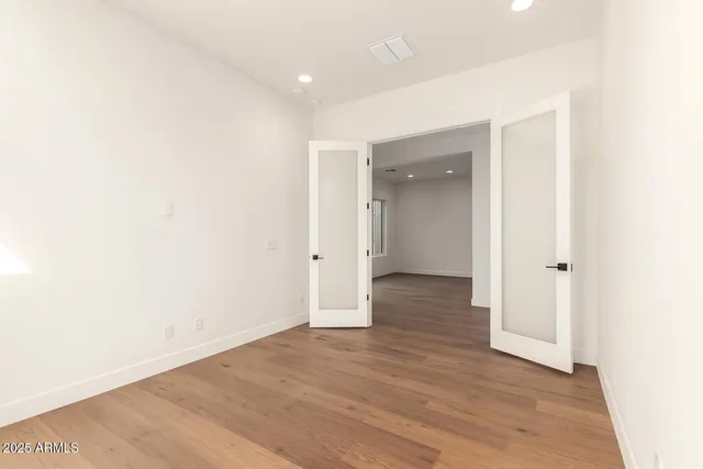 a view of a hallway with wooden floor