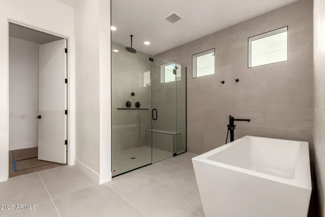 a bathroom with a bathtub and shower