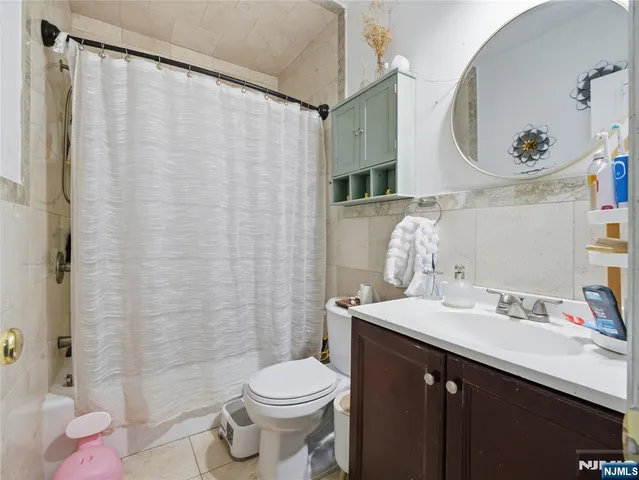a bathroom with a sink vanity mirror and toilet