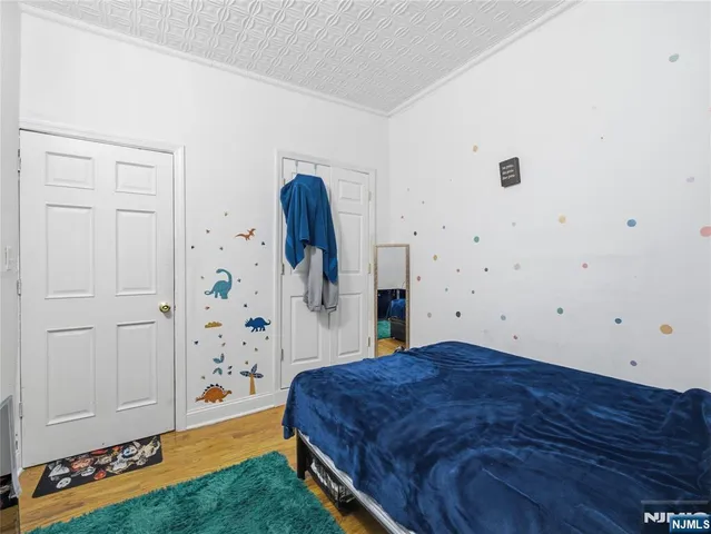 a spacious bedroom with a bed and a dresser