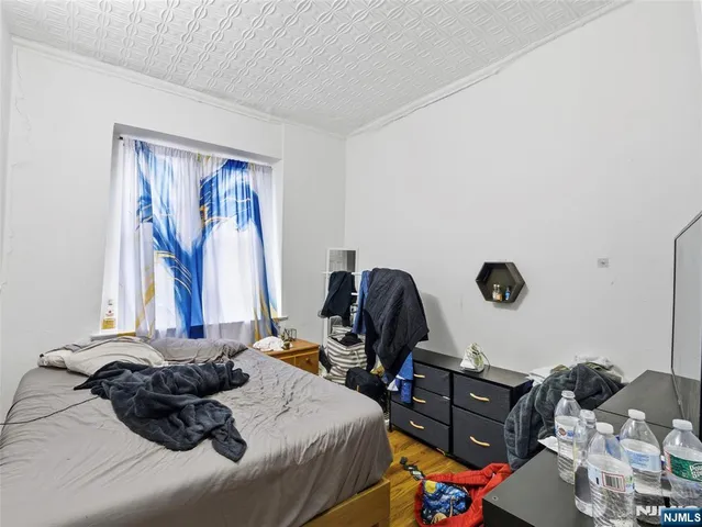 a bedroom with a bed and a chandelier