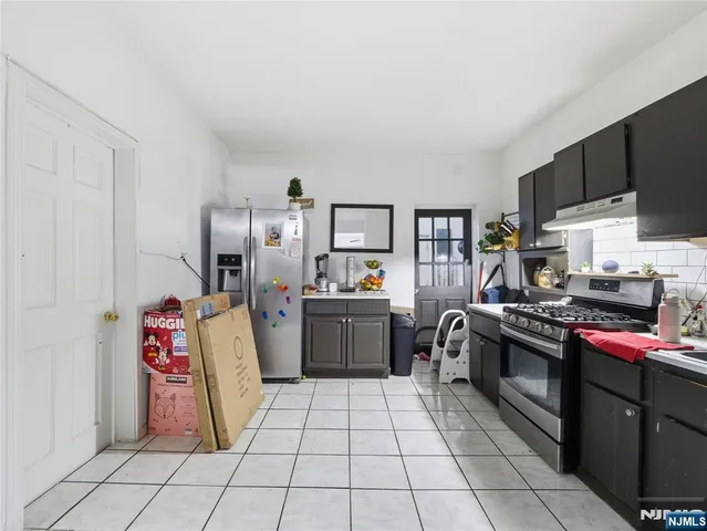 a kitchen with a sink and a stove top oven