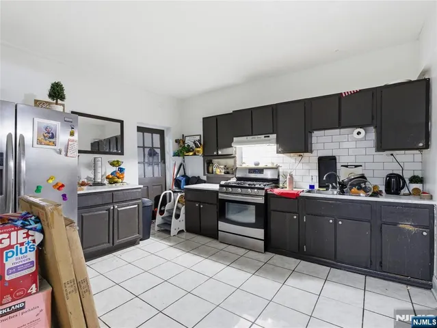 a kitchen with sink cabinets and stainless steel appliances