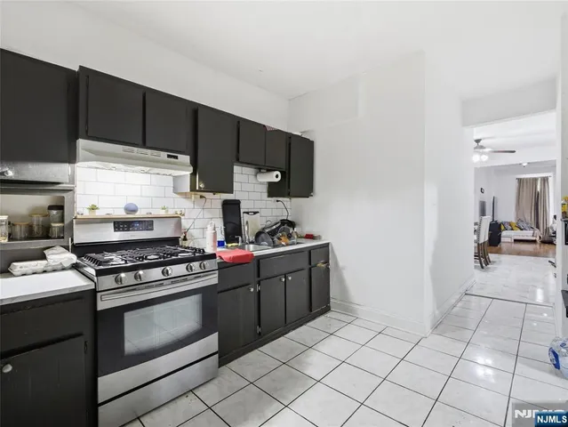 a kitchen with a stove and a refrigerator