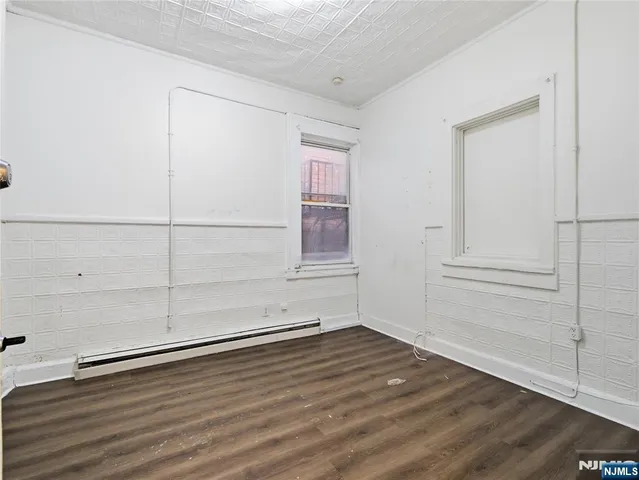 an empty room with wooden floor