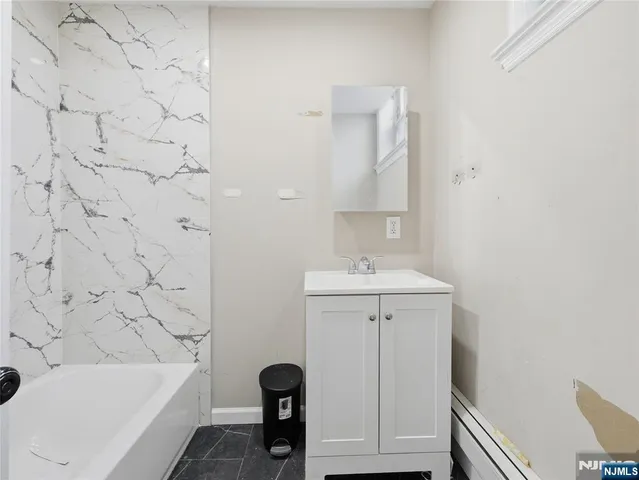 a bathroom with a sink a toilet and bathtub