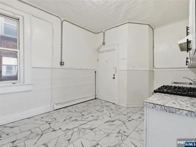 a kitchen with white cabinets and white appliances
