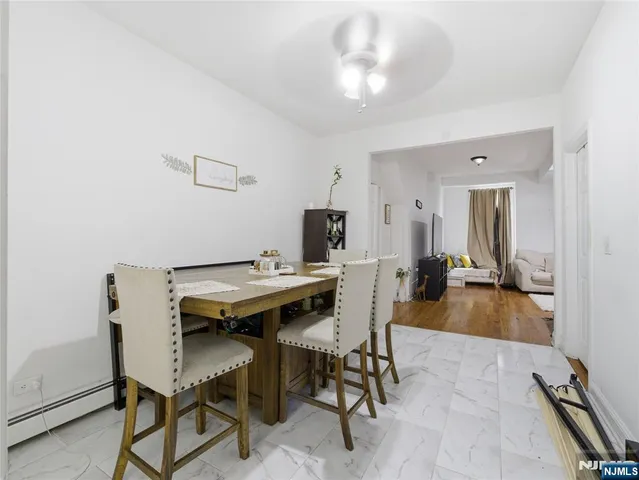 a view of a dining room with furniture and a chandelier