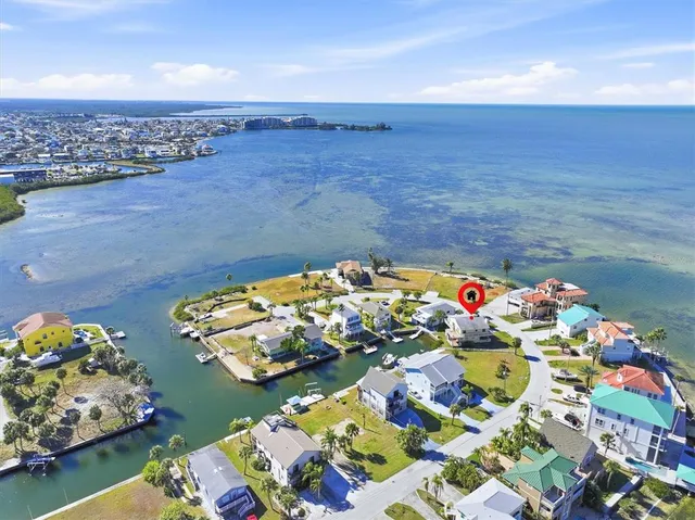a kitchen with stainless steel appliances granite countertop a stove a sink dishwasher and cabinets with wooden floor