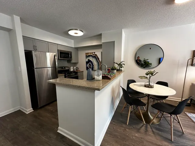 a room with furniture a mirror and a wooden floor