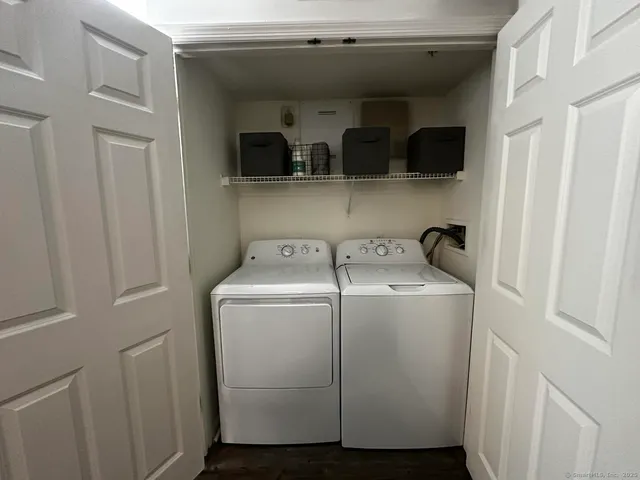 a view of storage and utility room with washer and dryer