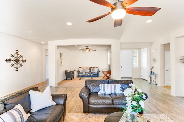 a kitchen with stainless steel appliances a dining table chairs and granite counter tops