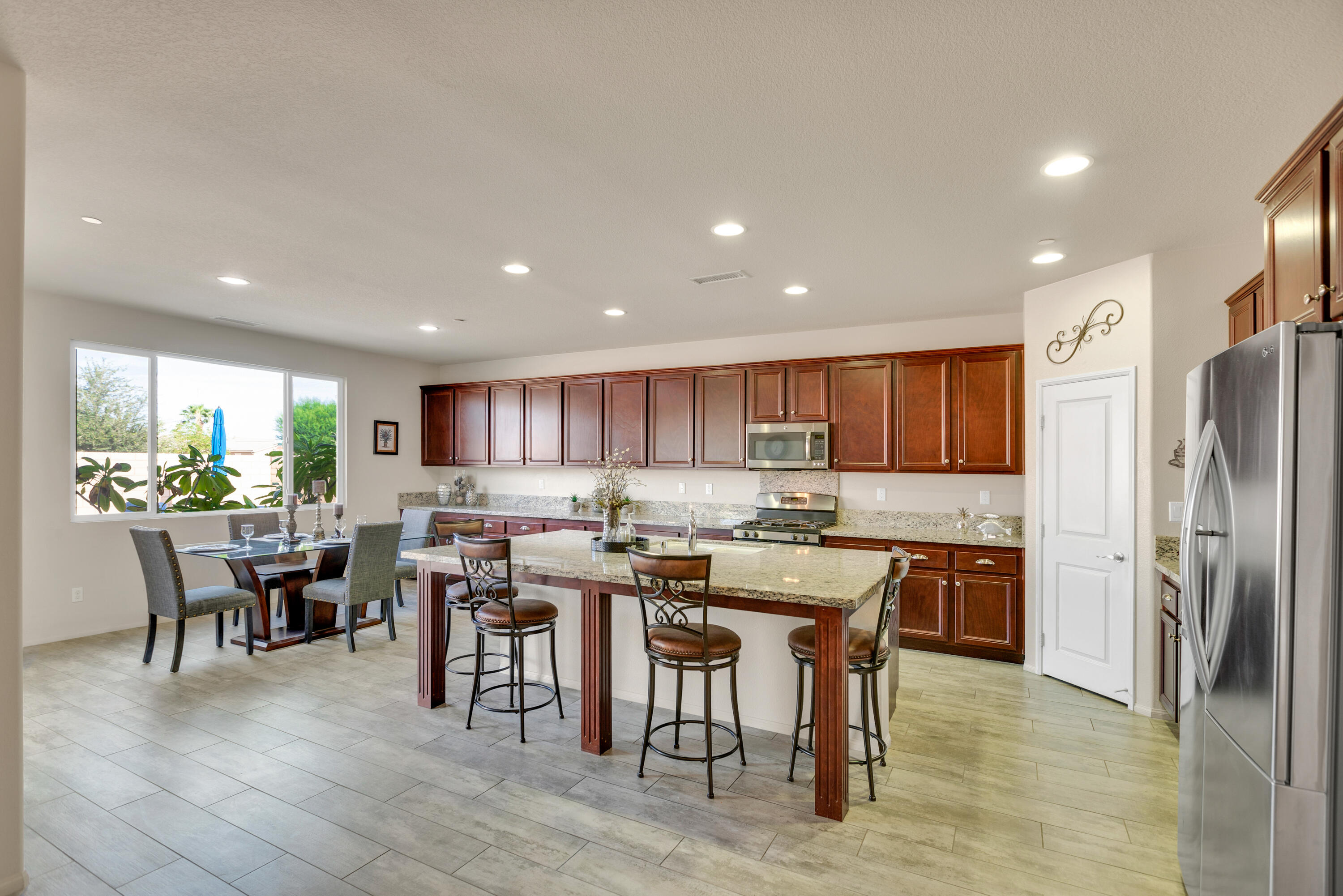 41344 Winfield Court Indio, CA 92203 - Photo 15 of 69 a kitchen with stainless steel appliances a dining table chairs and granite counter tops