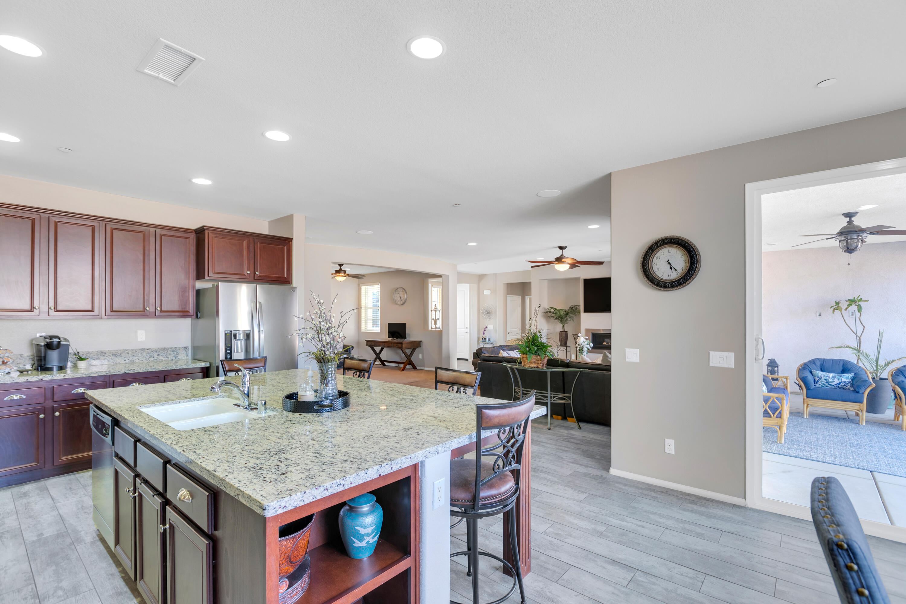 41344 Winfield Court Indio, CA 92203 - Photo 19 of 69 a kitchen with stainless steel appliances granite countertop a stove top oven a sink a dining table and chairs with wooden floor
