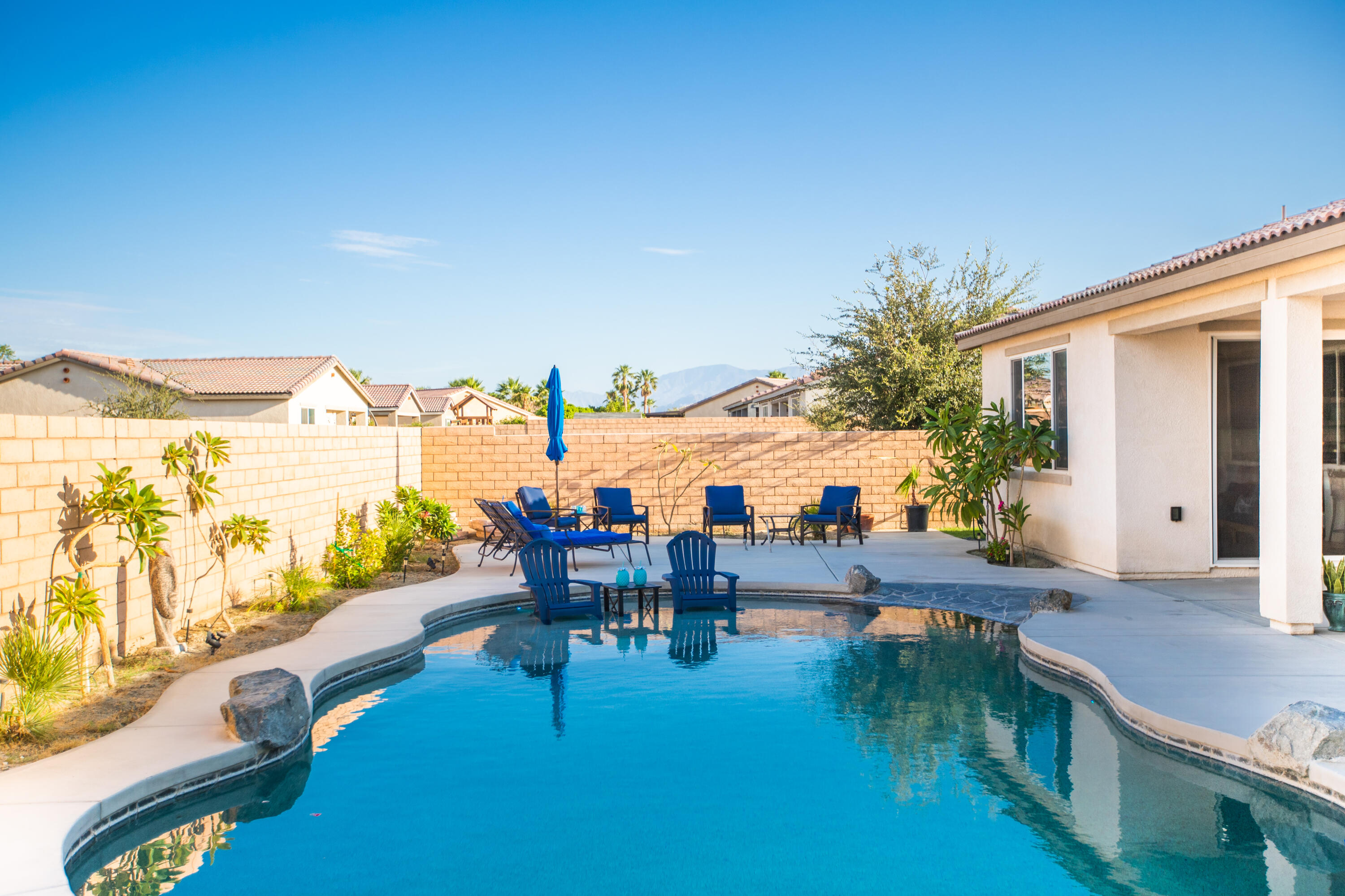 41344 Winfield Court Indio, CA 92203 - Photo 24 of 69 a view of a swimming pool with outdoor seating and plants