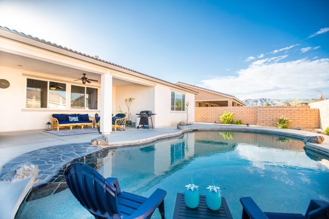 view of a hallway with wooden floor and a living room