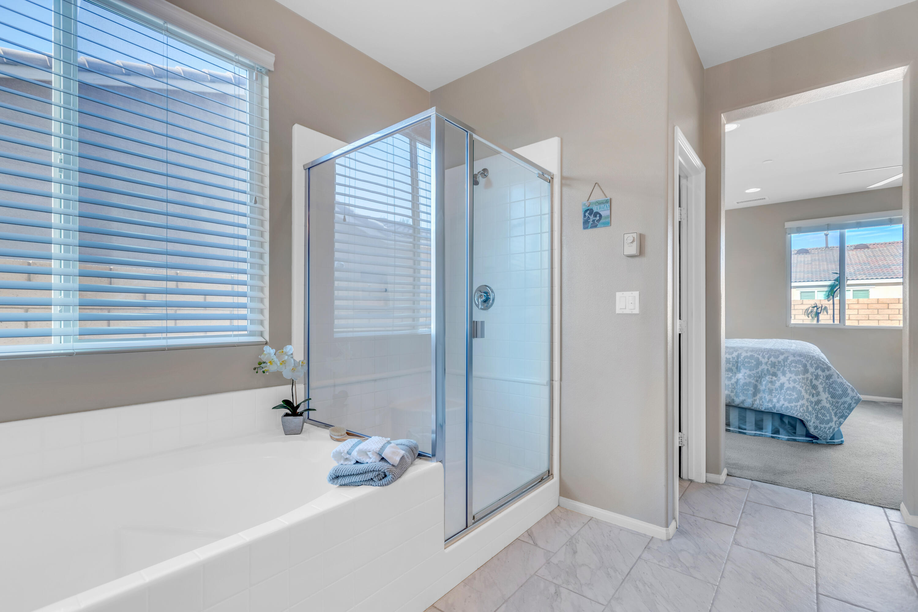 41344 Winfield Court Indio, CA 92203 - Photo 40 of 69 a bathroom with a tub shower and sink