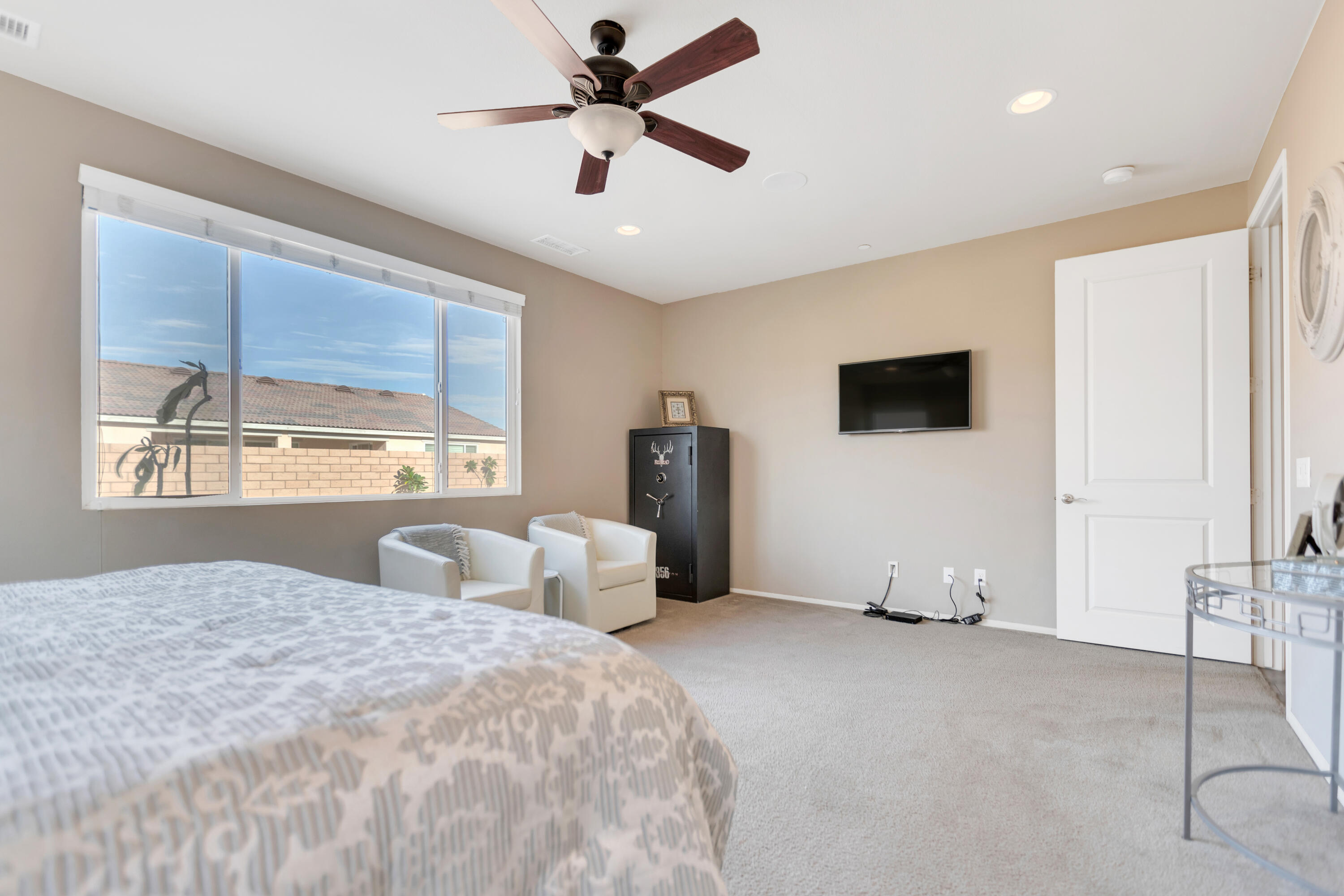 41344 Winfield Court Indio, CA 92203 - Photo 42 of 69 a bedroom with a large bed a flat tv screen and large window