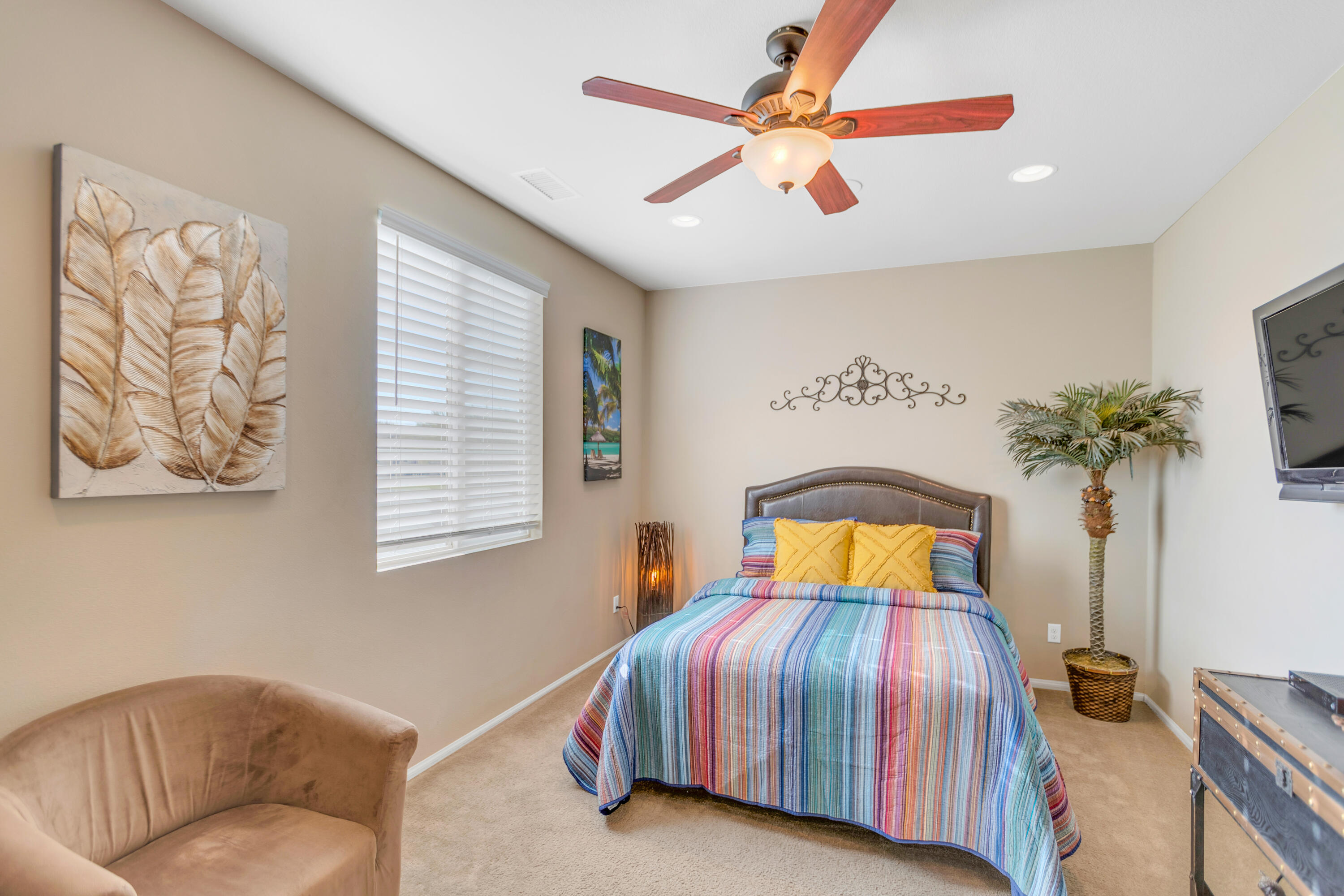 41344 Winfield Court Indio, CA 92203 - Photo 45 of 69 a bedroom with a large bed and a chandelier