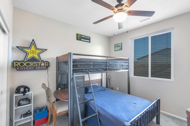 a living room with patio furniture and a potted plant