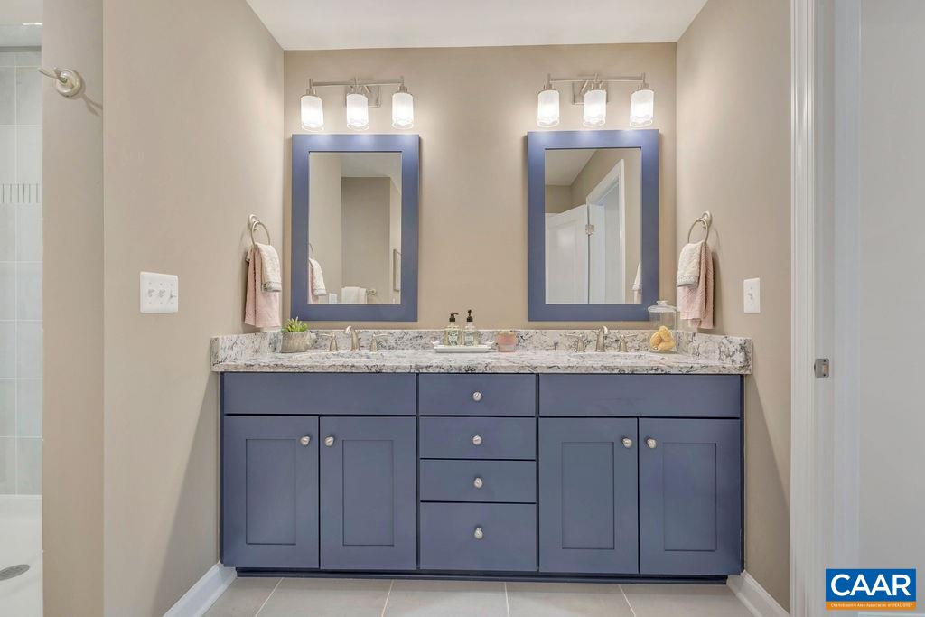 3264 Thicket Run Drive Charlottesville, VA 22911 - Photo 14 of 25 a bathroom with a granite countertop sink and a mirror
