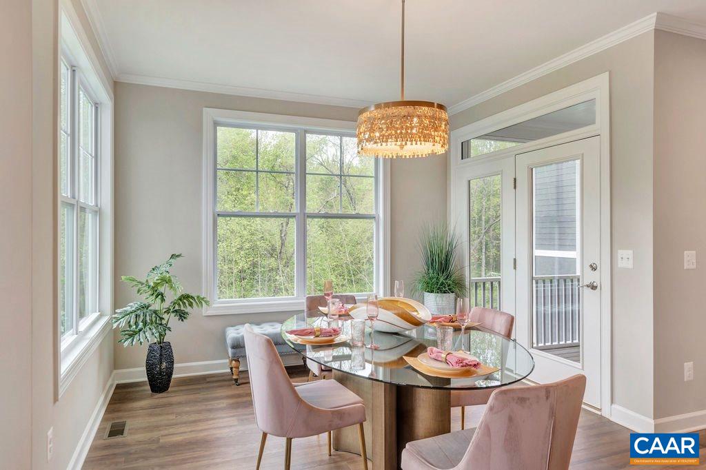 3264 Thicket Run Drive Charlottesville, VA 22911 - Photo 8 of 25 a view of a dining room with furniture wooden floor and chandelier