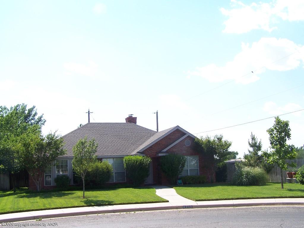 a view of a house with a yard and plants
