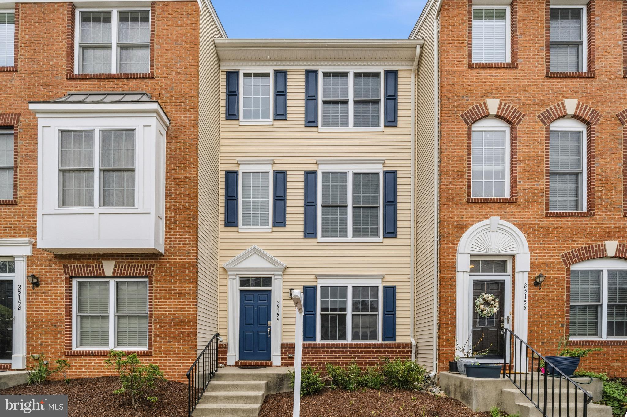 25154 Monteith Terrace Chantilly, VA 20152 - Photo 1 of 40 a front view of a house with a garden