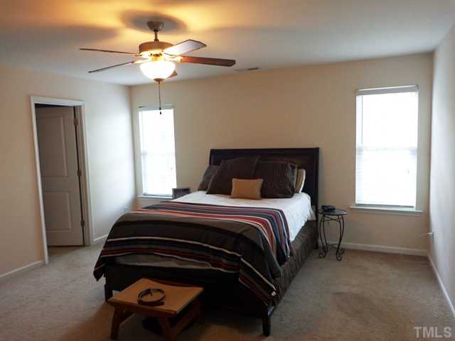 5139 Arbor Chase Drive Raleigh, NC 27616 - Photo 13 of 25 a bedroom with a bed and a chandelier