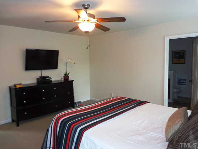 5139 Arbor Chase Drive Raleigh, NC 27616 - Photo 14 of 25 a bedroom with a bed and a flat screen tv