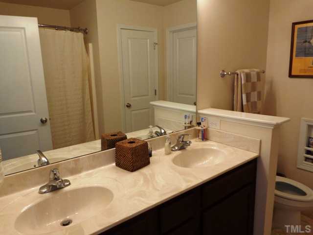 5139 Arbor Chase Drive Raleigh, NC 27616 - Photo 17 of 25 a bathroom with a sink and a mirror