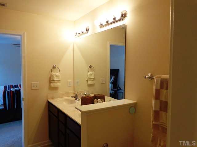 5139 Arbor Chase Drive Raleigh, NC 27616 - Photo 18 of 25 a bathroom with a sink mirror and vanity