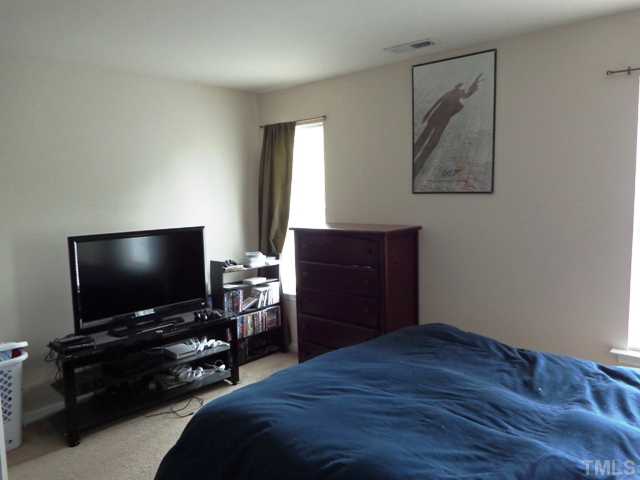 5139 Arbor Chase Drive Raleigh, NC 27616 - Photo 20 of 25 a bedroom with a bed and a flat screen tv