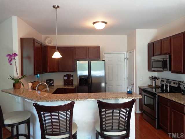 5139 Arbor Chase Drive Raleigh, NC 27616 - Photo 2 of 25 a kitchen with a sink and a refrigerator