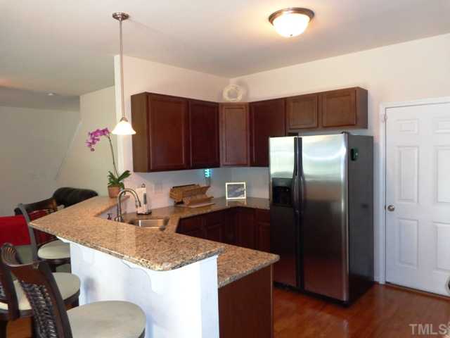 5139 Arbor Chase Drive Raleigh, NC 27616 - Photo 3 of 25 a kitchen with stainless steel appliances granite countertop a sink refrigerator and cabinets