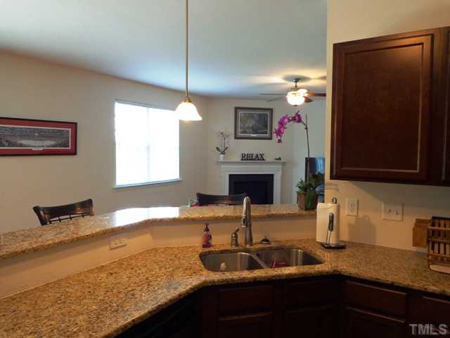 5139 Arbor Chase Drive Raleigh, NC 27616 - Photo 7 of 25 a kitchen with a sink and a microwave