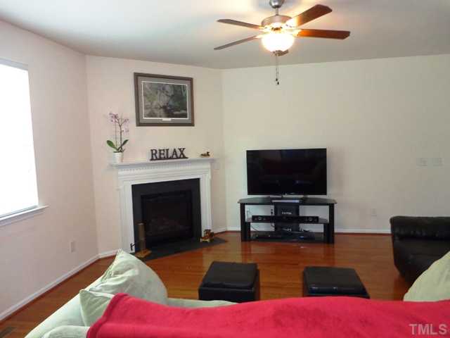 5139 Arbor Chase Drive Raleigh, NC 27616 - Photo 8 of 25 a living room with furniture and a flat screen tv