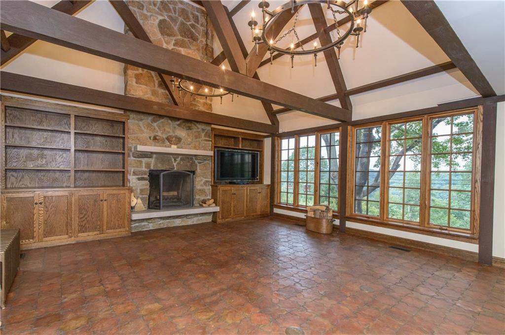 21 Newgate Road Pittsburgh, PA 15202 - Photo 4 of 25 Enter into the family room with soaring ceilings and beam construction with a stunning floor to ceiling wood burning fireplace. If this isnt enough, the wall of windows offer exquisite views of the valley below.