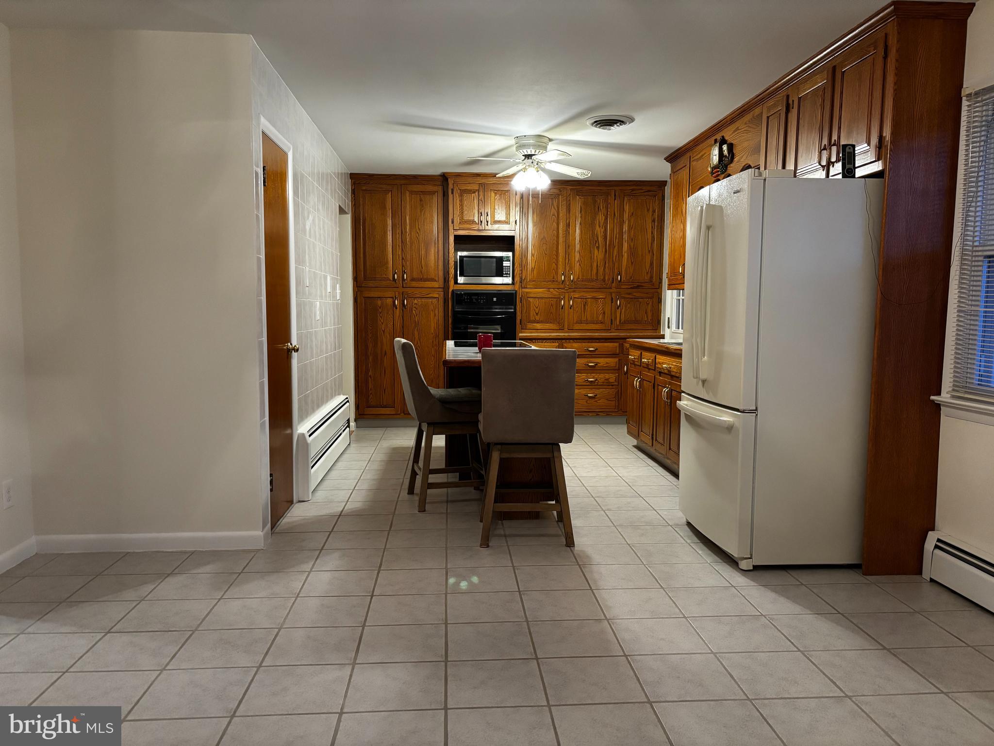 23230 Colton Point Road Avenue, MD 20609 - Photo 11 of 44 a kitchen with stainless steel appliances a refrigerator and a stove top oven
