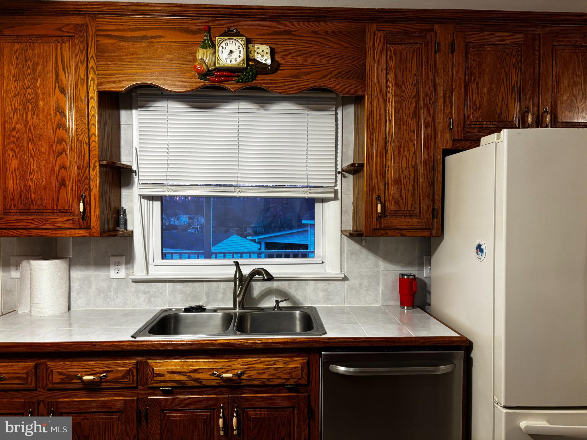 23230 Colton Point Road Avenue, MD 20609 - Photo 16 of 44 a kitchen with stainless steel appliances a sink a stove a refrigerator and cabinets