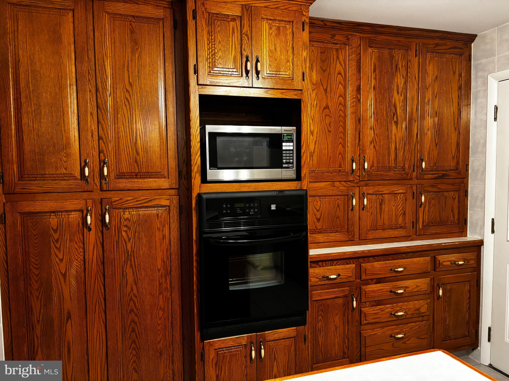 23230 Colton Point Road Avenue, MD 20609 - Photo 17 of 44 a kitchen with granite countertop wooden cabinets and a stove top oven