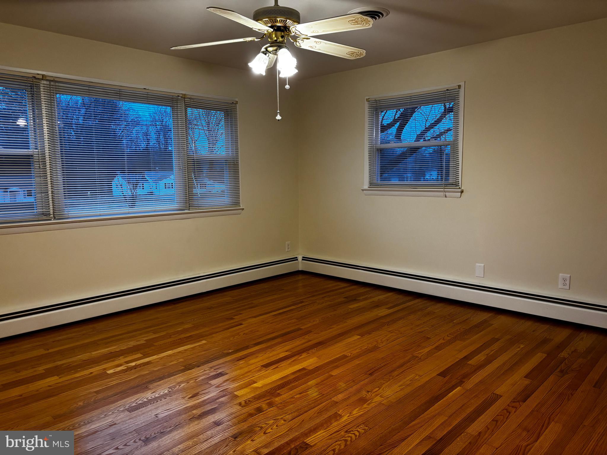 23230 Colton Point Road Avenue, MD 20609 - Photo 22 of 44 a view of an empty room with wooden floor and a chandelier fan