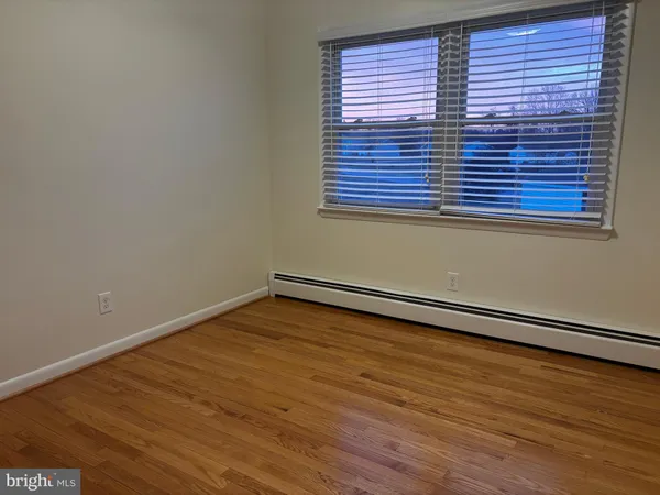 a view of a room with wooden floor and a window