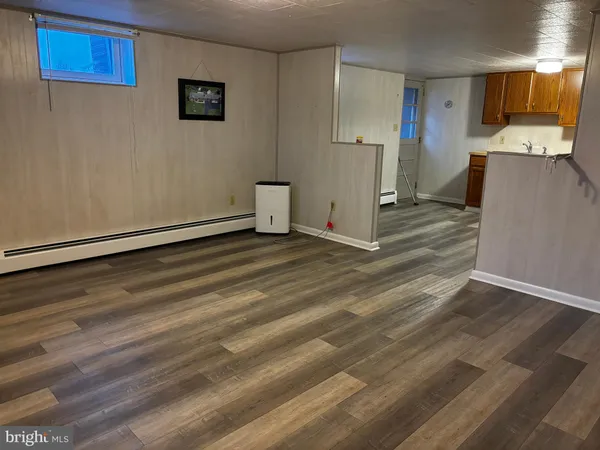 a view of a kitchen with wooden floor and electronic appliances