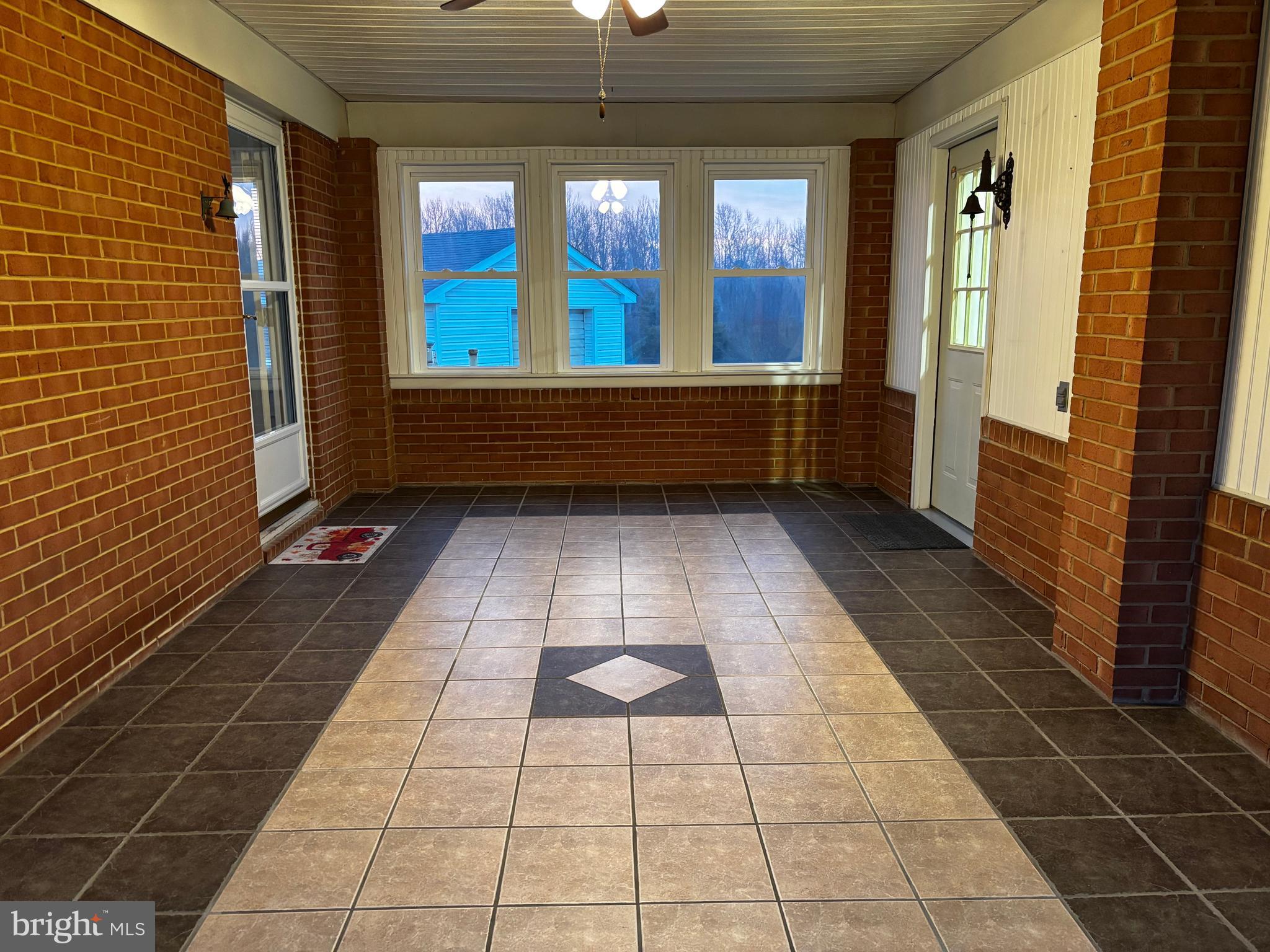 23230 Colton Point Road Avenue, MD 20609 - Photo 4 of 44 a view of empty room with wooden floor and fan