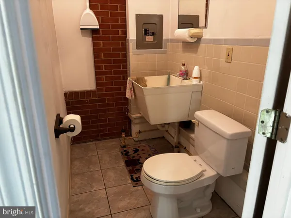 a bathroom with a toilet and a mirror
