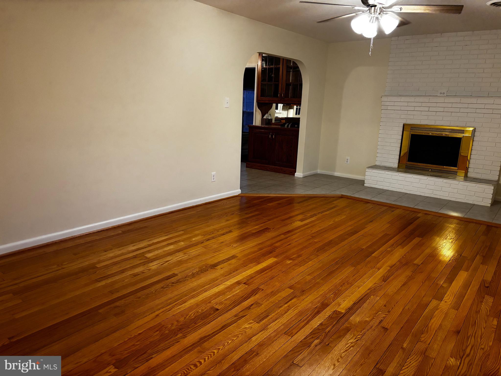 23230 Colton Point Road Avenue, MD 20609 - Photo 8 of 44 a view of an empty room with chandelier fan and fire place